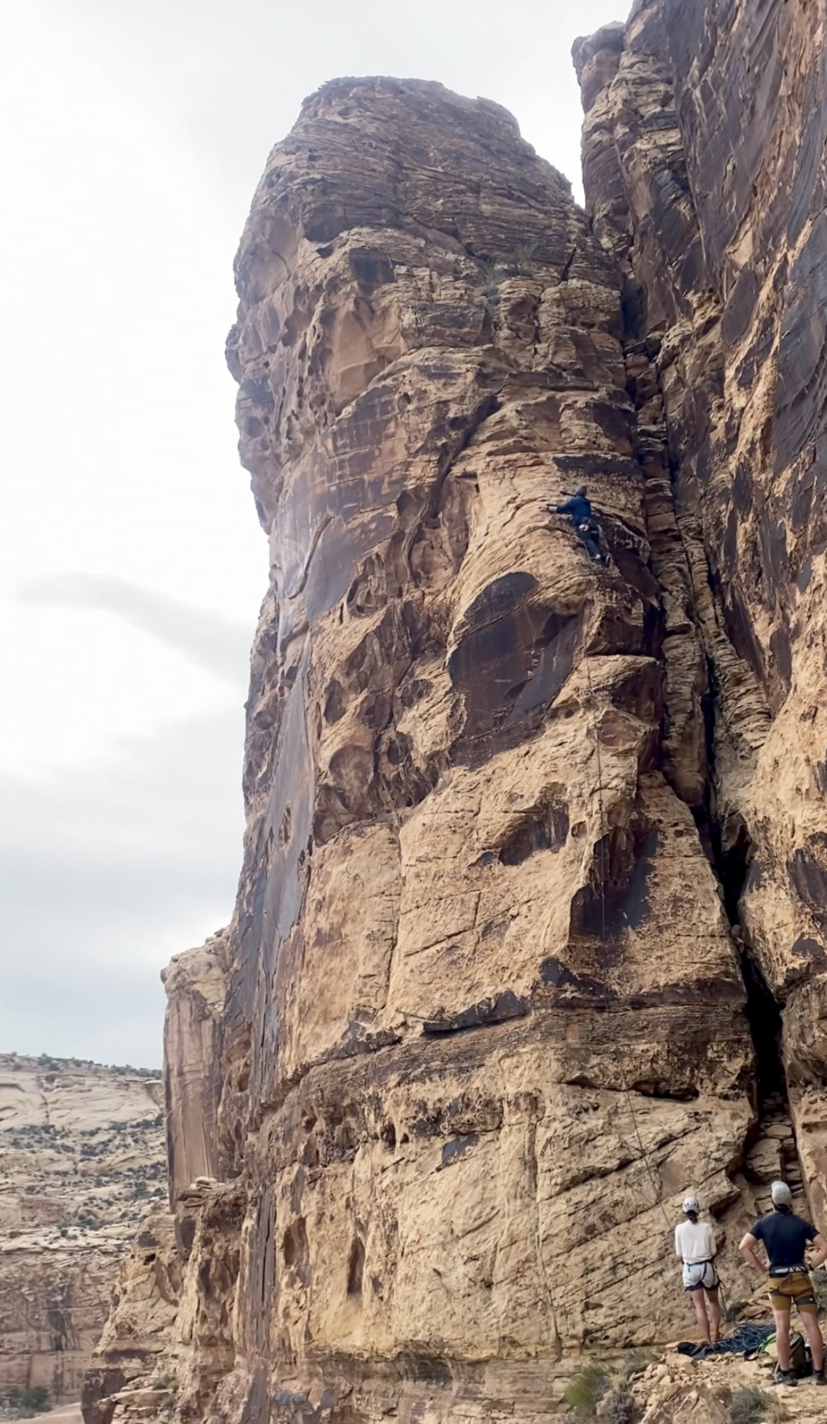 Climber on a sandstone wall representing the rehab-to-performance continuum